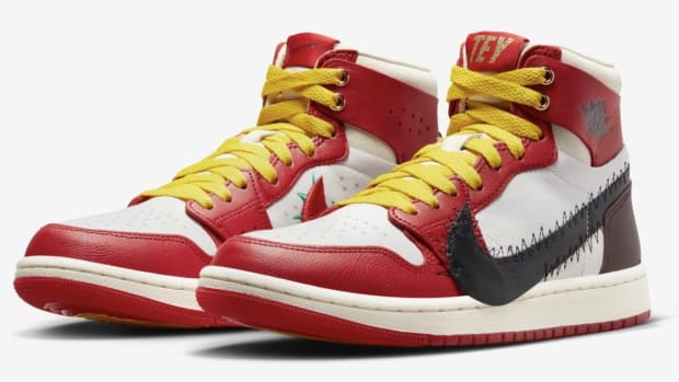 Side view of red, white, and black Air Jordan sneakers.